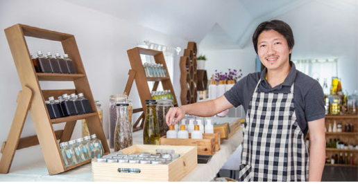 A man standing inside his business.